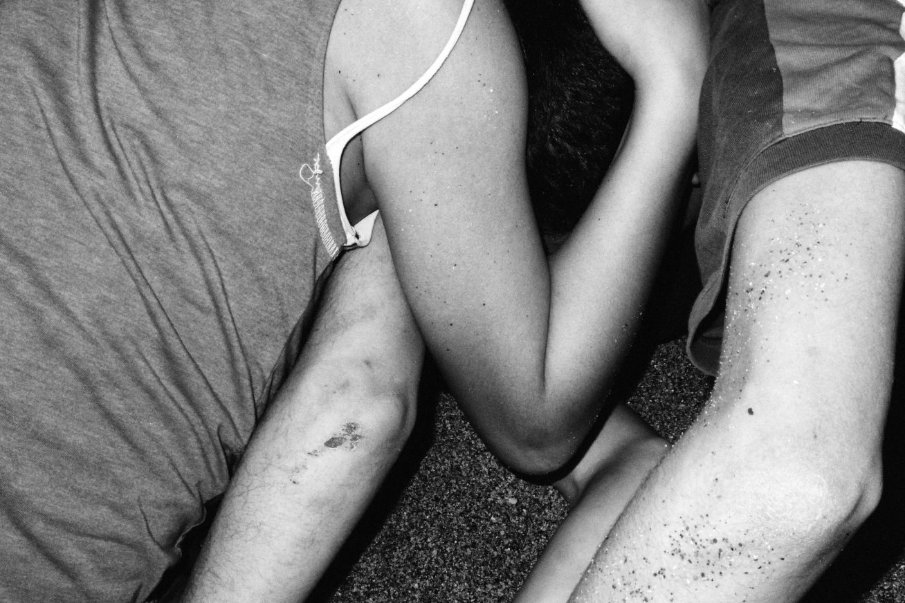 The arms and legs of two people entwined