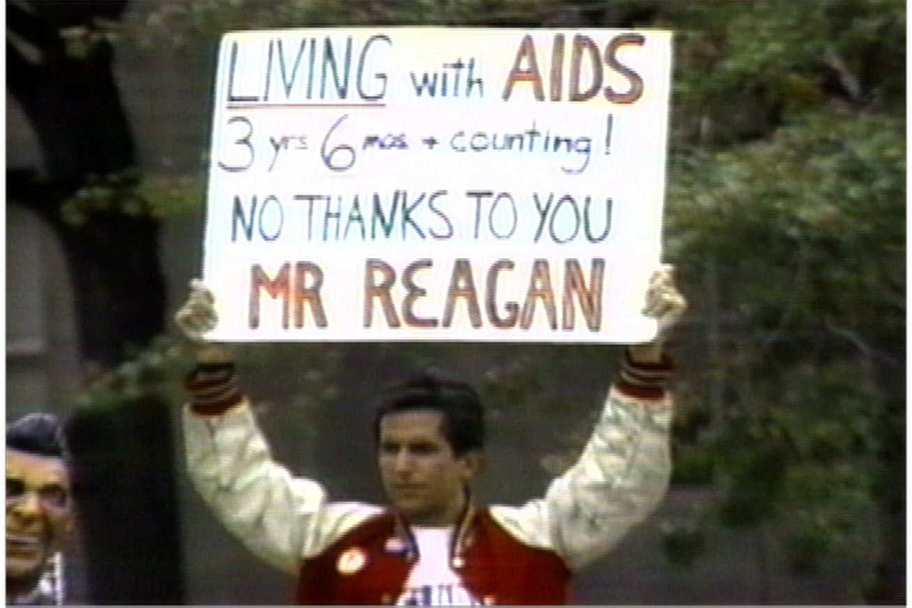 A person holds up a sign at a protest