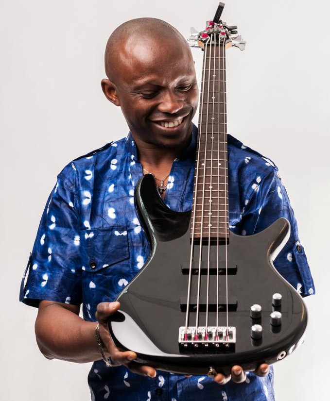 A man in a blue shirt poses with a bass guitar - part of the Focus Africa line-up